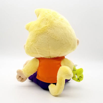 Yellow plush toy with spiky head, orange shirt, purple pants, and a tail, holding a small green creature, viewed from behind