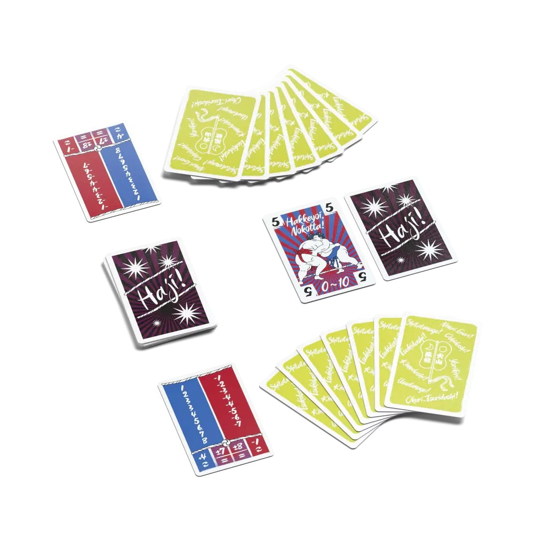 A collection of colorful game cards, featuring sumo wrestlers, Japanese text, "Haji!" cards, and number cards, displayed on white