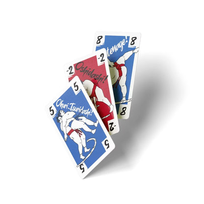 Three playing cards with sumo wrestlers in action poses, fanned diagonally on a white background. Cards are blue and red