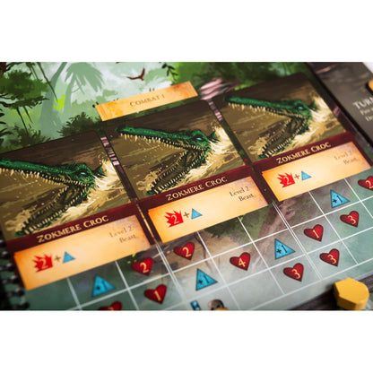 Close-up of a board game with three 'Zokmere Croc' monster cards, featuring fierce green crocodiles in water, plus combat stats