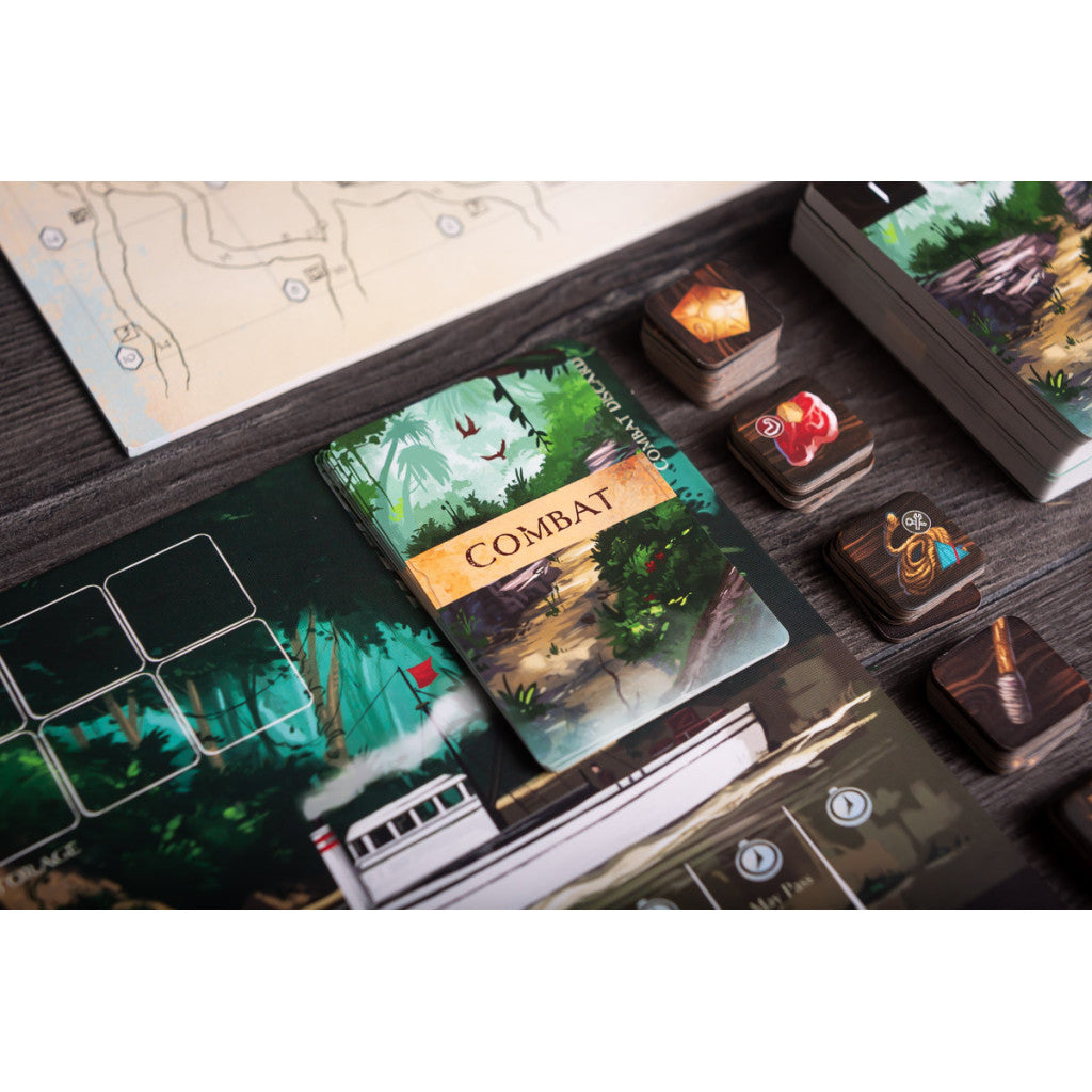 A board game setup featuring a "Combat" card, jungle-themed playmat, item tokens, and map on a wooden table