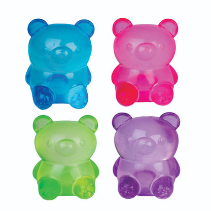 Four sparkly, translucent gummy bears: blue, pink, green, and purple