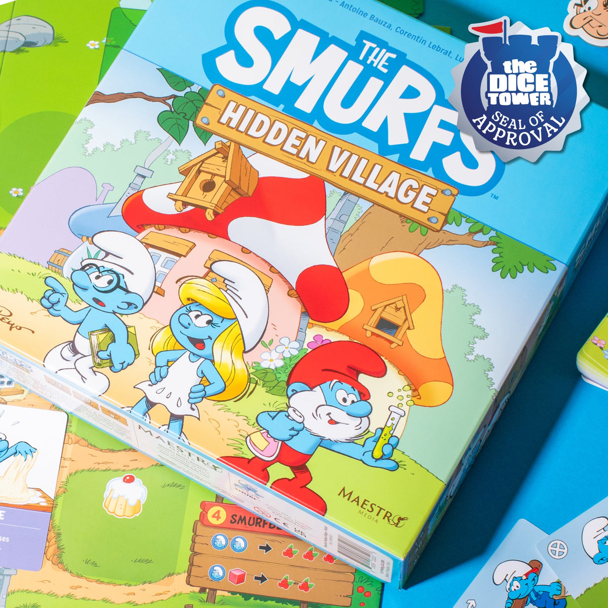 The Smurfs: Hidden Village board game box featuring Brainy, Smurfette, and Papa Smurf, with a &#39;Dice Tower Seal of Approval&#39;.