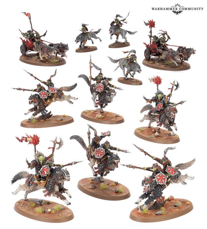 A host of painted Warhammer miniatures: Orruk wolf riders, cavalry, and wolf-drawn chariots
