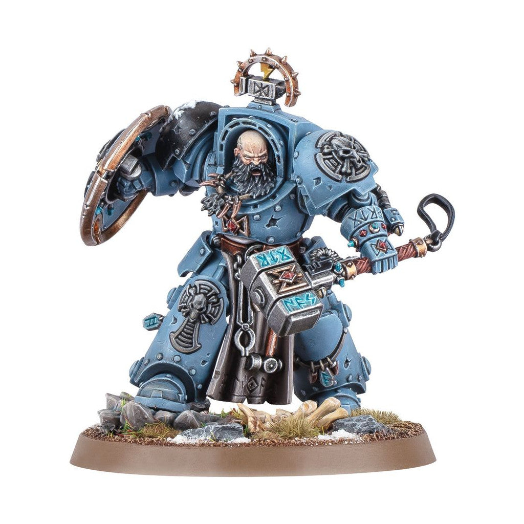 Warhammer 40,000 Space Marine miniature in blue-grey power armor, Bearded warrior holds a shield and ornate runic hammer