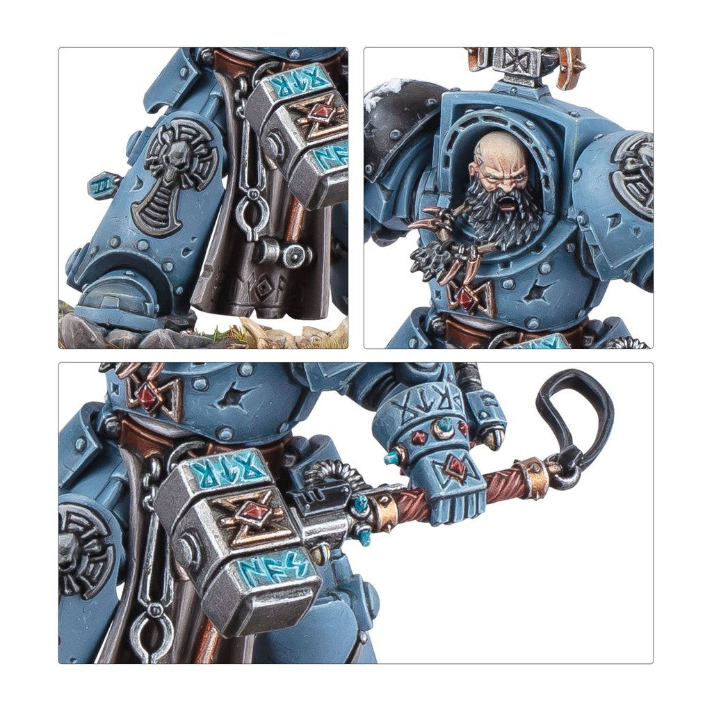 Grey-blue armored Space Marine miniature, bald and bearded, holds an ornate runic hammer