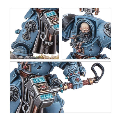 Grey-blue armored Space Marine miniature, bald and bearded, holds an ornate runic hammer