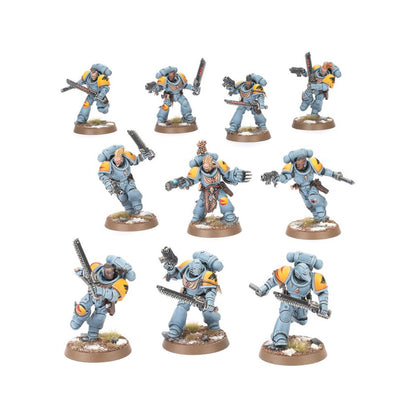 Ten Space Wolves Warhammer 40K miniatures in light blue/grey armor with yellow trim, wielding chainswords and bolt pistols