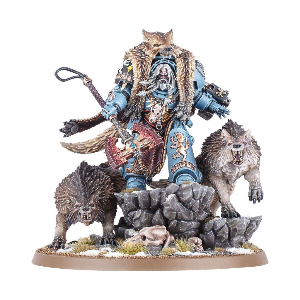 A Warhammer 40k Space Wolf miniature: a blue armored warrior with an axe stands on rocks, flanked by two snarling wolves