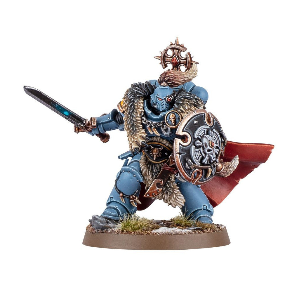Blue armored warrior miniature with fur cloak, wielding a glowing sword and a skull-adorned shield