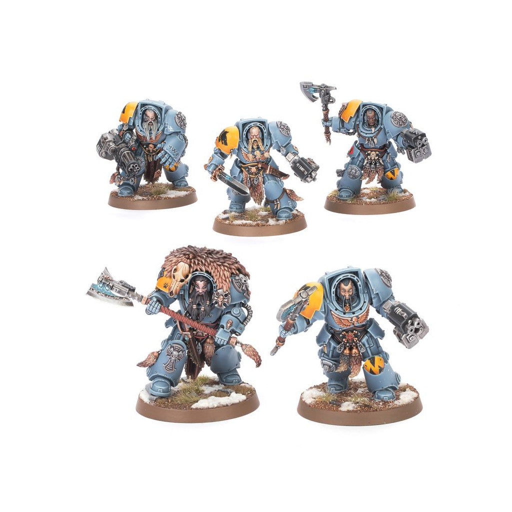 Five painted Warhammer 40k Space Wolves miniatures in grey armor, adorned with fur and wielding axes and guns