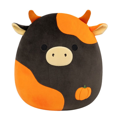 A black and orange Halloween cow Squishmallow plush with a small pumpkin stitched on its body