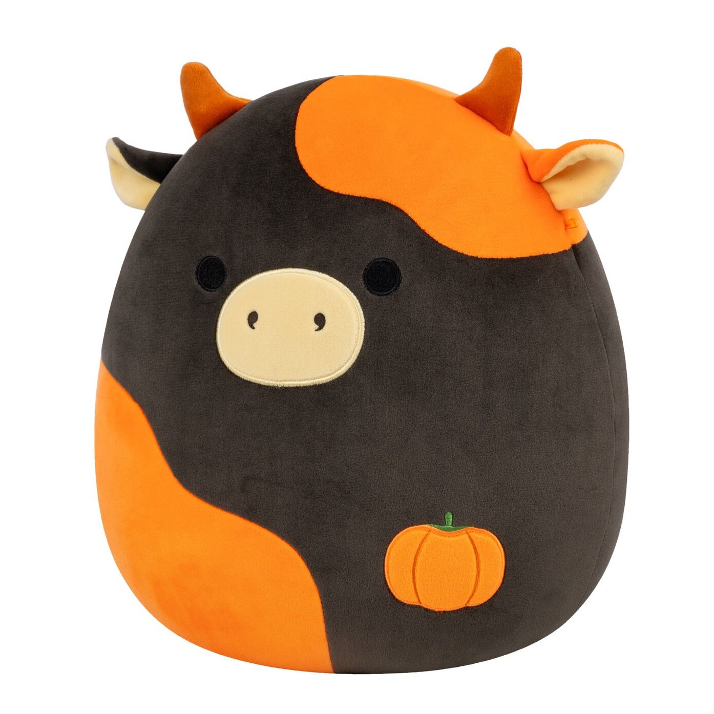 A black and orange cow plush with horns, a tan snout, and an embroidered pumpkin on its side