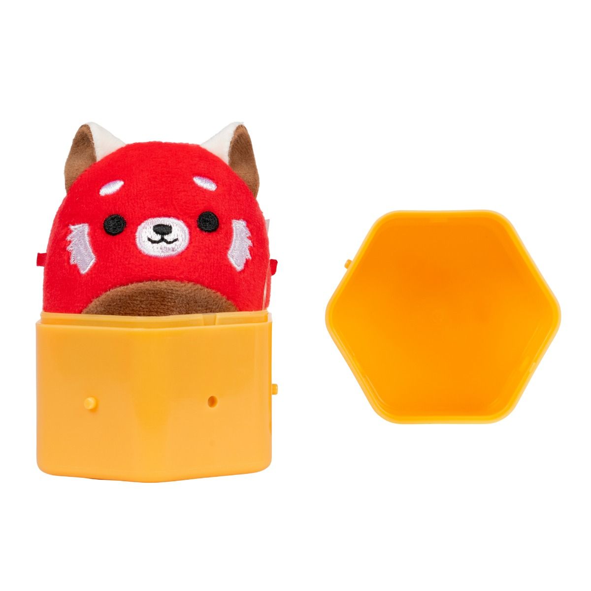Red panda plush popping out of an open yellow hexagonal toy capsule