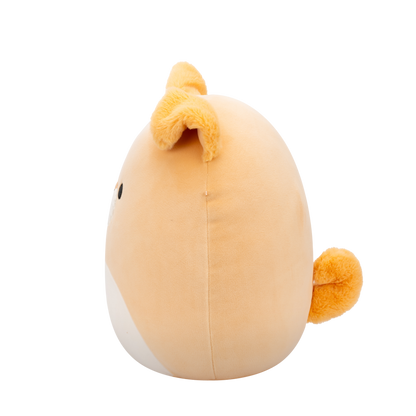 Side view of peach-colored Squishmallow Shiba Inu plush toy with black eyes, white muzzle, embroidered smile, and fuzzy orange ears