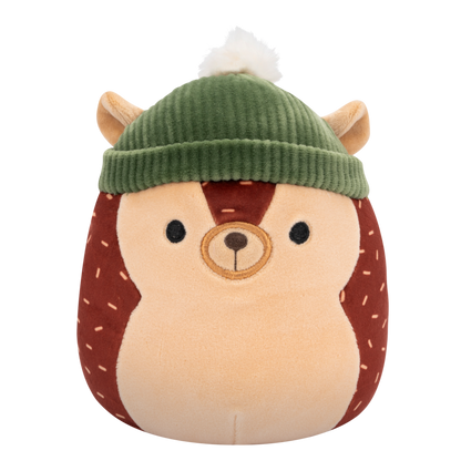 Squishmallow hedgehog plush toy with a brown body, tan face, and light brown dash patterns, wearing a green ribbed beanie with a white pom-pom