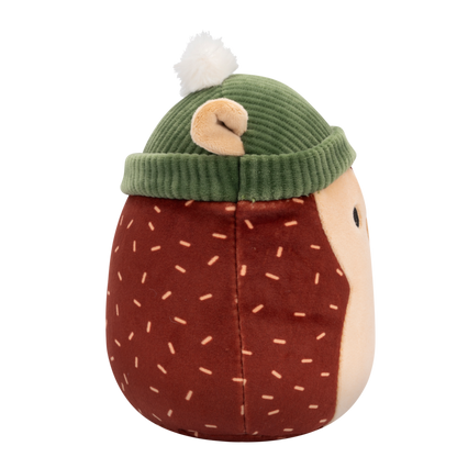 Side view of Squishmallow hedgehog plush toy with a brown body, tan face, and light brown dash patterns, wearing a green ribbed beanie with a white pom-pom