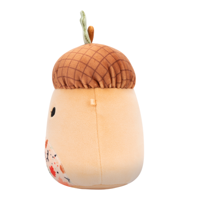 Side view of plush toy with a textured brown cap, green leaf stem, friendly face, and a belly patterned with colorful autumn leaves and mushrooms
