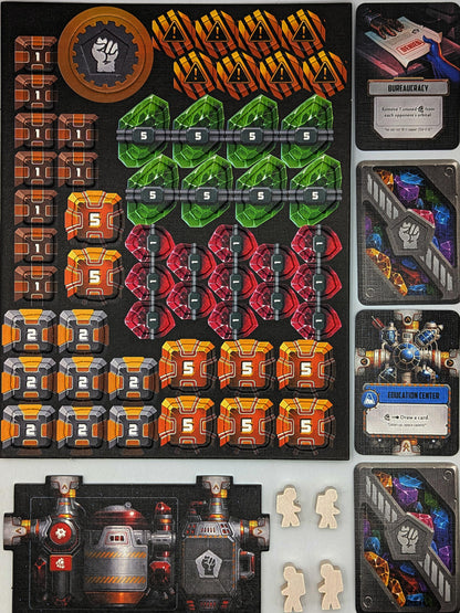 Star Scrappers: Orbital board game components spread out: colorful crystal and crate tokens, sci-fi cards, a factory tile, and astronaut meeples