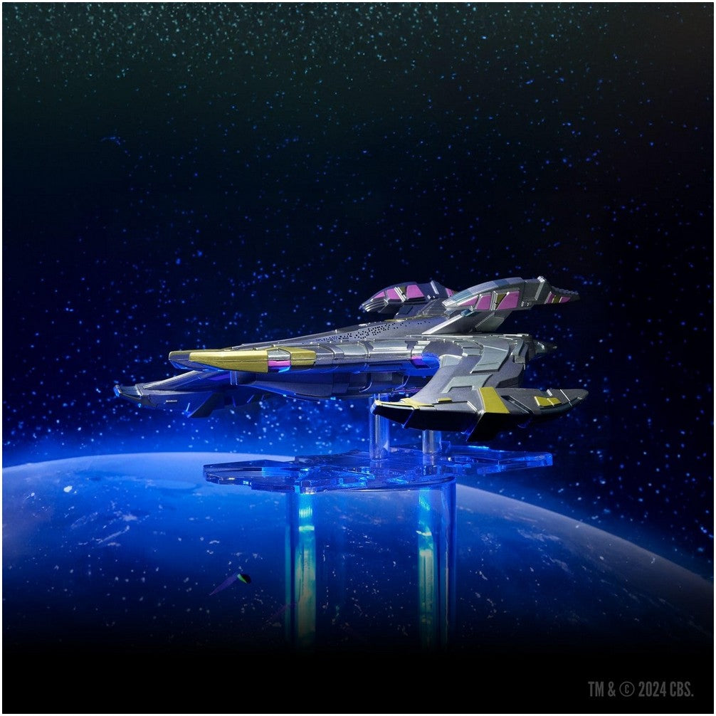 A gray, yellow, and purple spaceship model on a glowing blue stand, displayed above a blue planet and starry sky