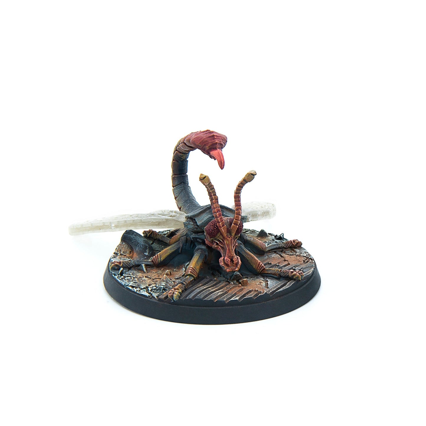Painted miniature of a dark, insectoid creature with a scorpion tail, raised stinger, and long antennae, on a rocky base
