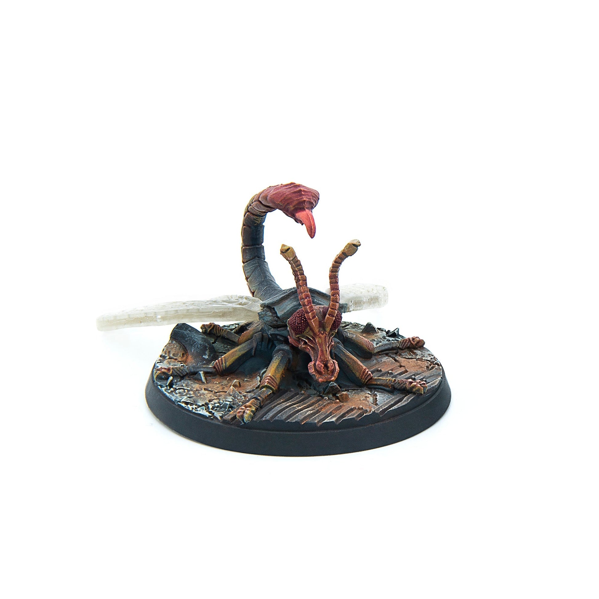 Painted miniature of a dark, insectoid creature with a scorpion tail, raised stinger, and long antennae, on a rocky base