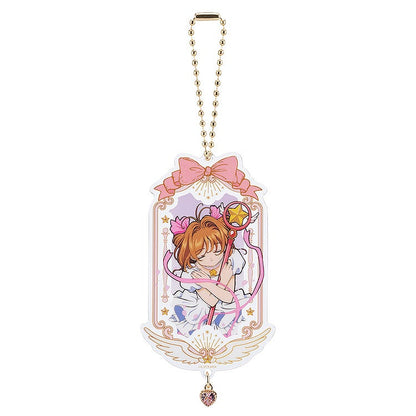 Cardcaptor Sakura 25th anniversary acrylic keychain featuring Sakura in a white dress holding a star staff with a pink ribbon and heart charm