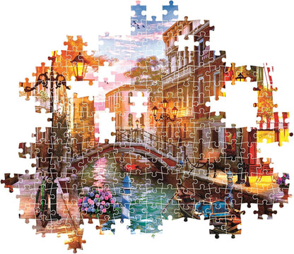 Partially completed jigsaw puzzle showing a Venetian canal scene at sunset with a bridge