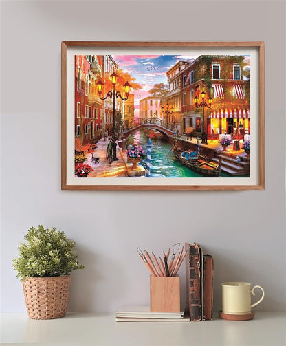 A vibrant framed painting of a Venice canal scene with illuminated street lamps and a gondola