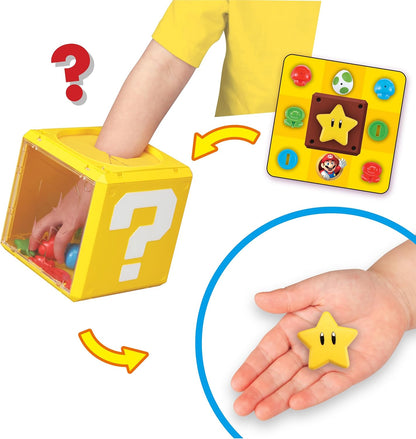 Hand reaching into a yellow Super Mario Question Block to retrieve a Power Star toy, shown with a display board