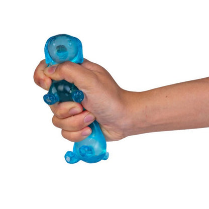 A hand squeezes a translucent blue dog toy