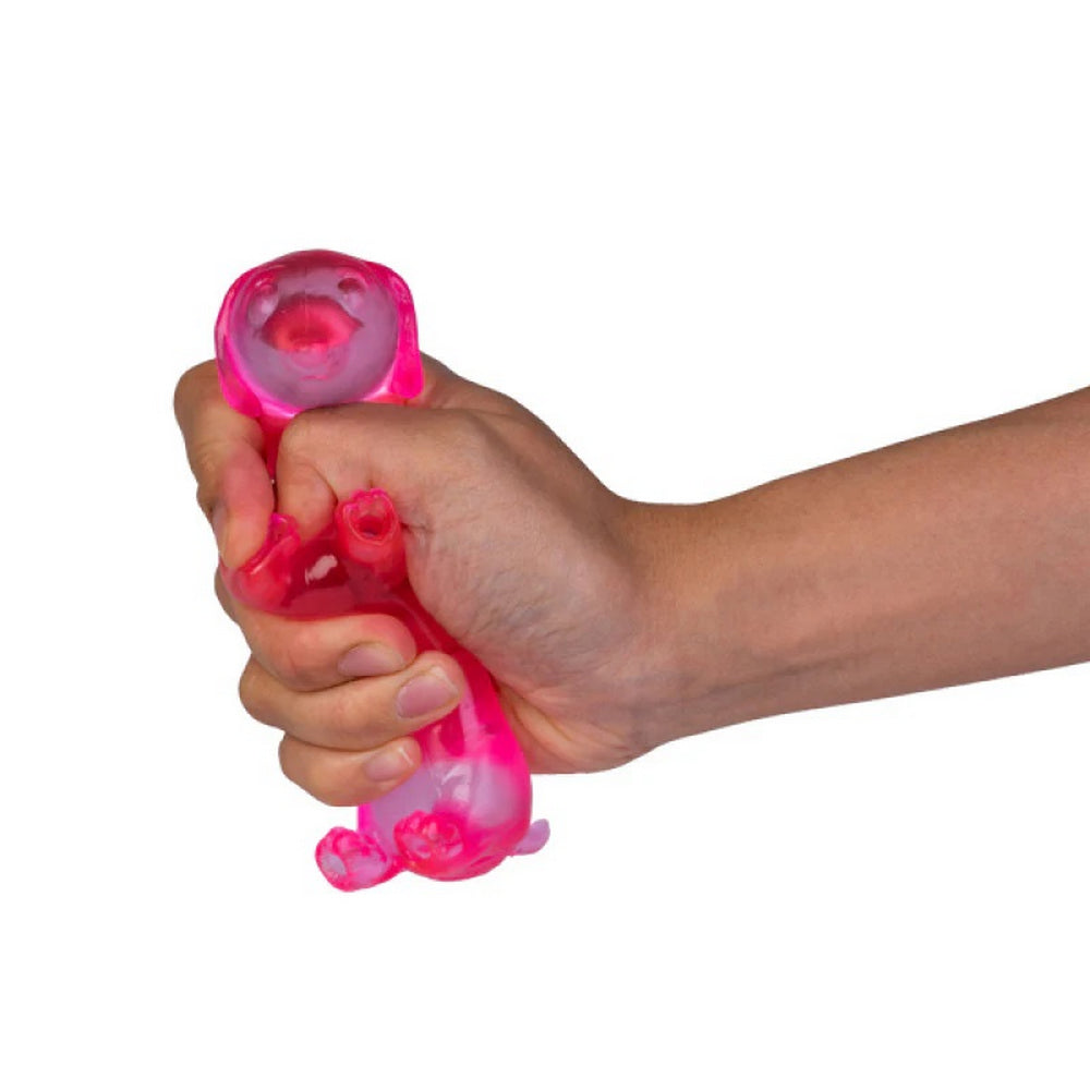 A hand squeezes a translucent pink dog-shaped stress toy