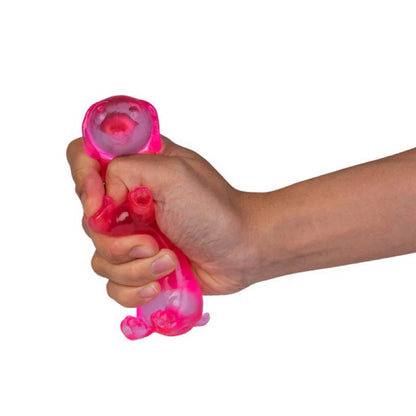 A hand squeezes a translucent pink dog-shaped stress toy