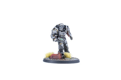 Miniature figure of a metallic grey Fallout T-45 Power Armor, blue eyes, holding a rifle, on a base with grass and rusted debris