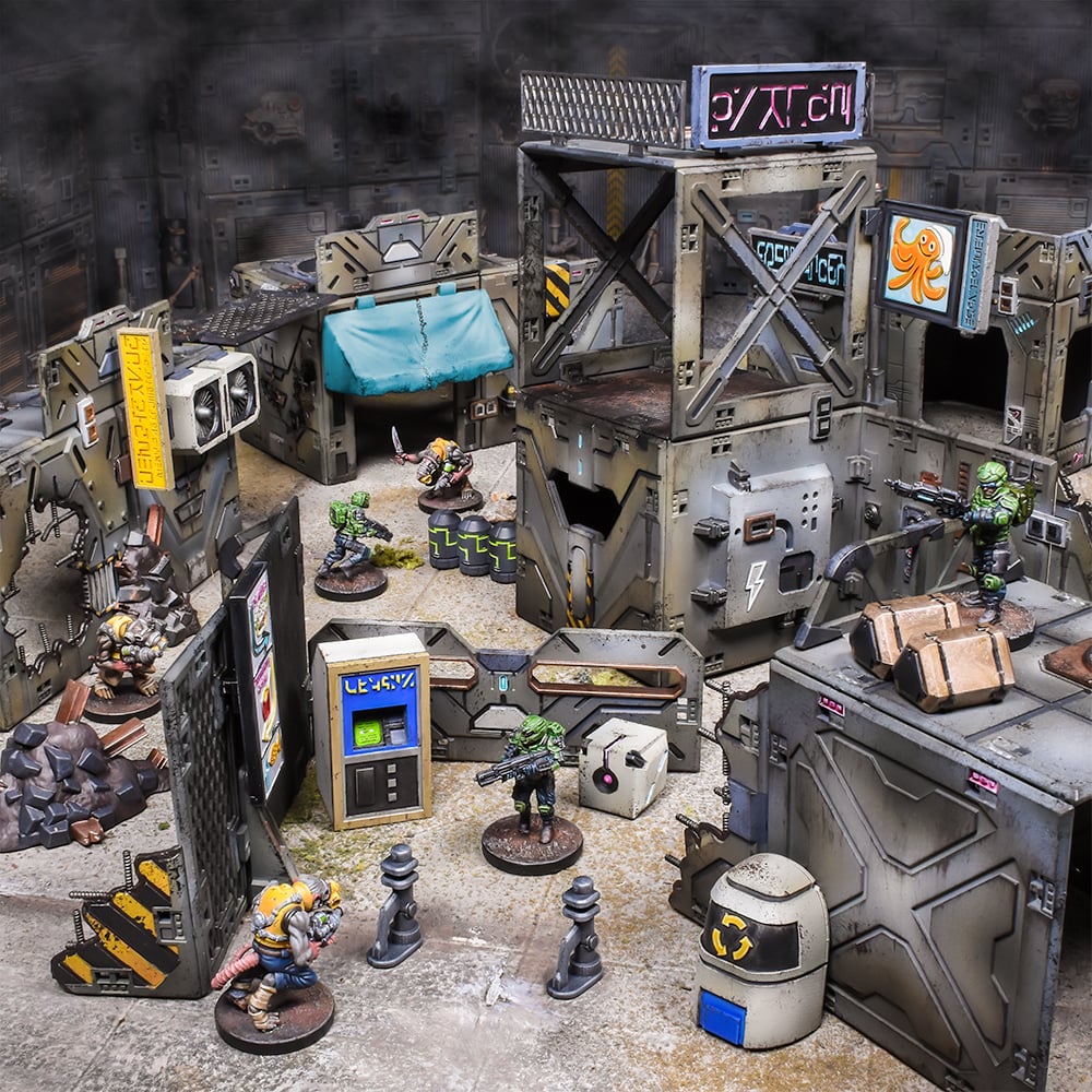 A futuristic tabletop wargame scene with detailed modular buildings and diverse armed miniatures