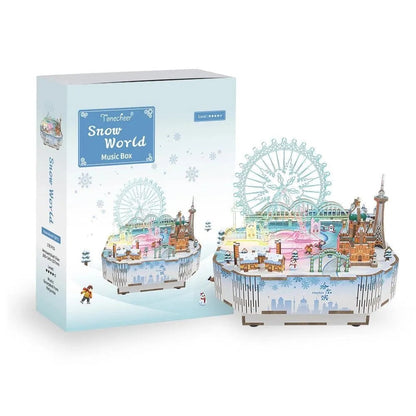Snow World 3D wooden music box puzzle kit featuring a miniature snowy cityscape and a Ferris wheel, displayed with its box