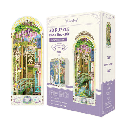 3D Puzzle Book Nook Kit box (Giverny Garden theme) showing a miniature scene with a green bridge and pink wisteria
