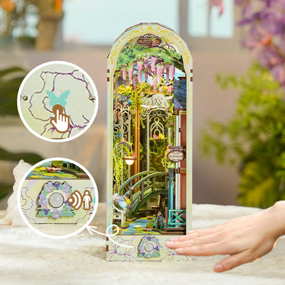 Detailed book nook miniature of a wisteria garden and bridge. Insets emphasize touch-activated light and motion sensors