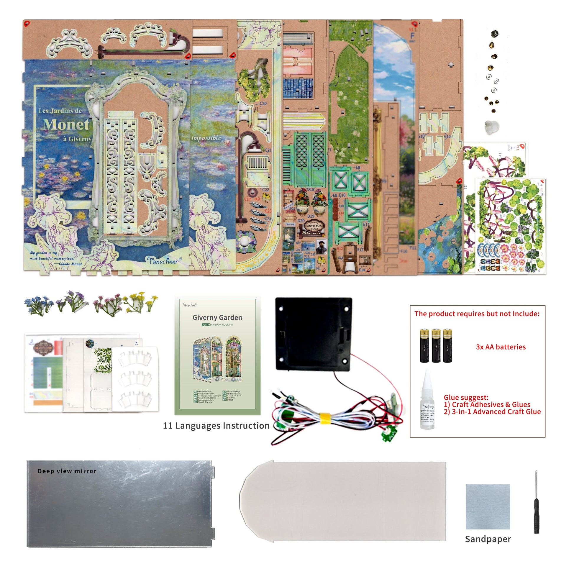 DIY Monet Giverny Garden book nook kit, showing unassembled die-cut pieces, instructions, electronic lighting, and tools