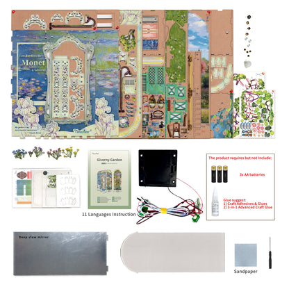 DIY Monet Giverny Garden book nook kit, showing unassembled die-cut pieces, instructions, electronic lighting, and tools