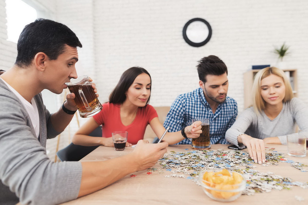 Friends enjoying drinks and a puzzle