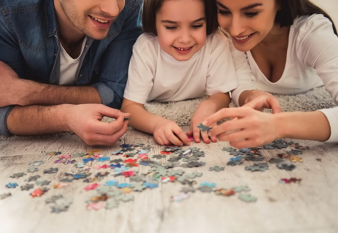 Family on floor doing a jigsaw puzzle