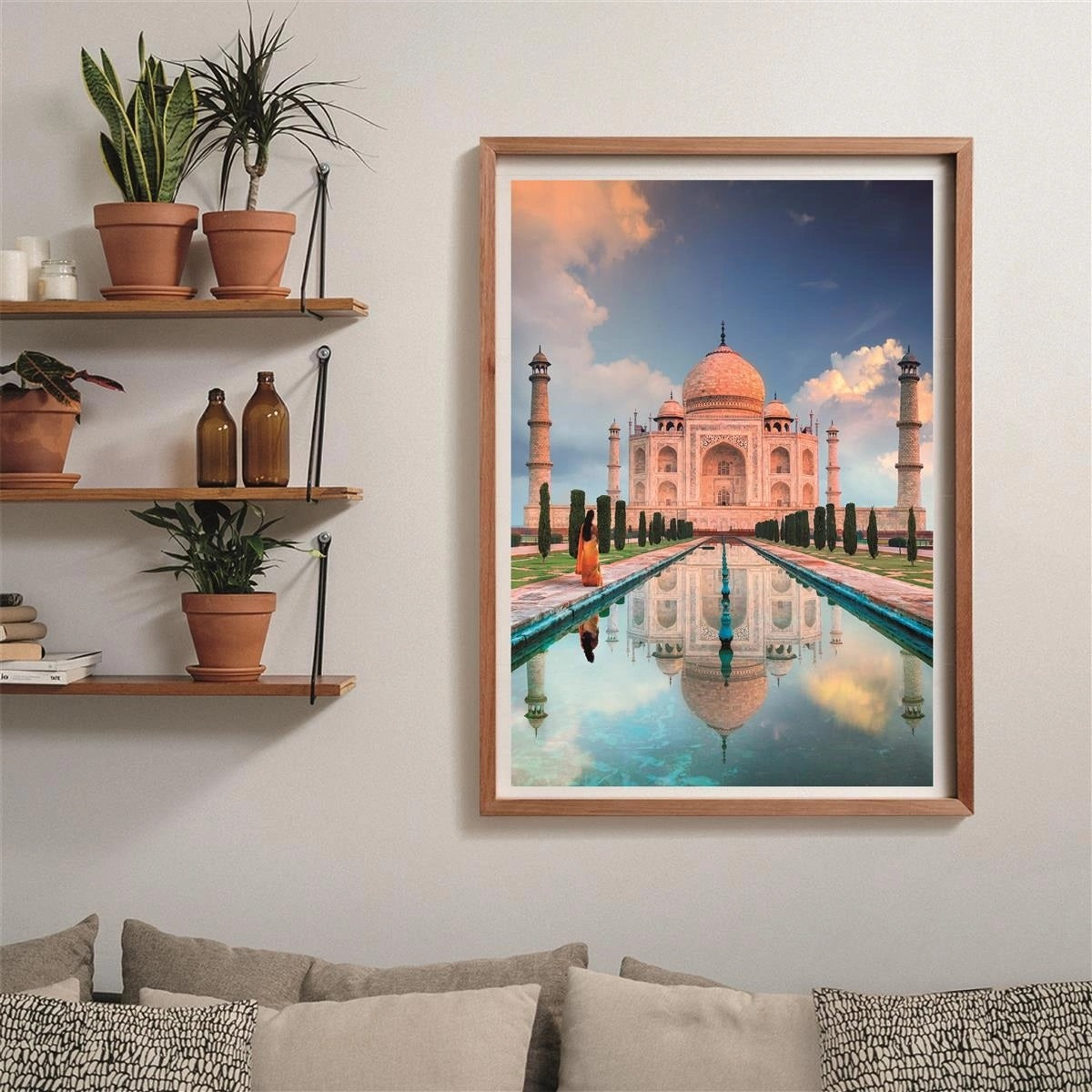 Framed print: Taj Mahal reflecting in a pool, person in orange walks towards it under an orange-blue sky
