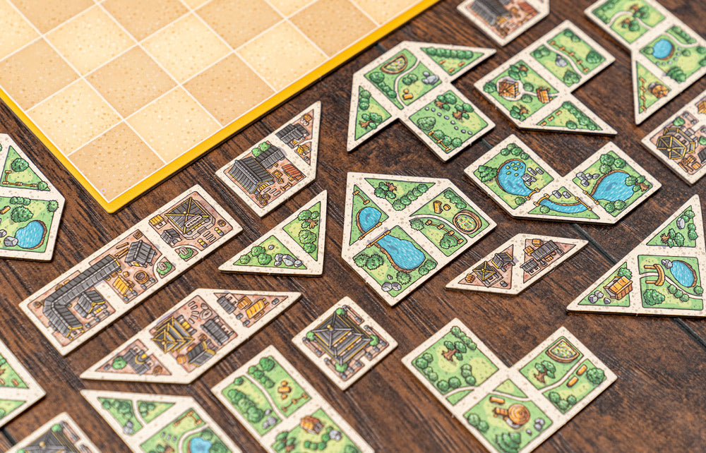 Player hand holding tangram tiles, planning their next move in Tangram City