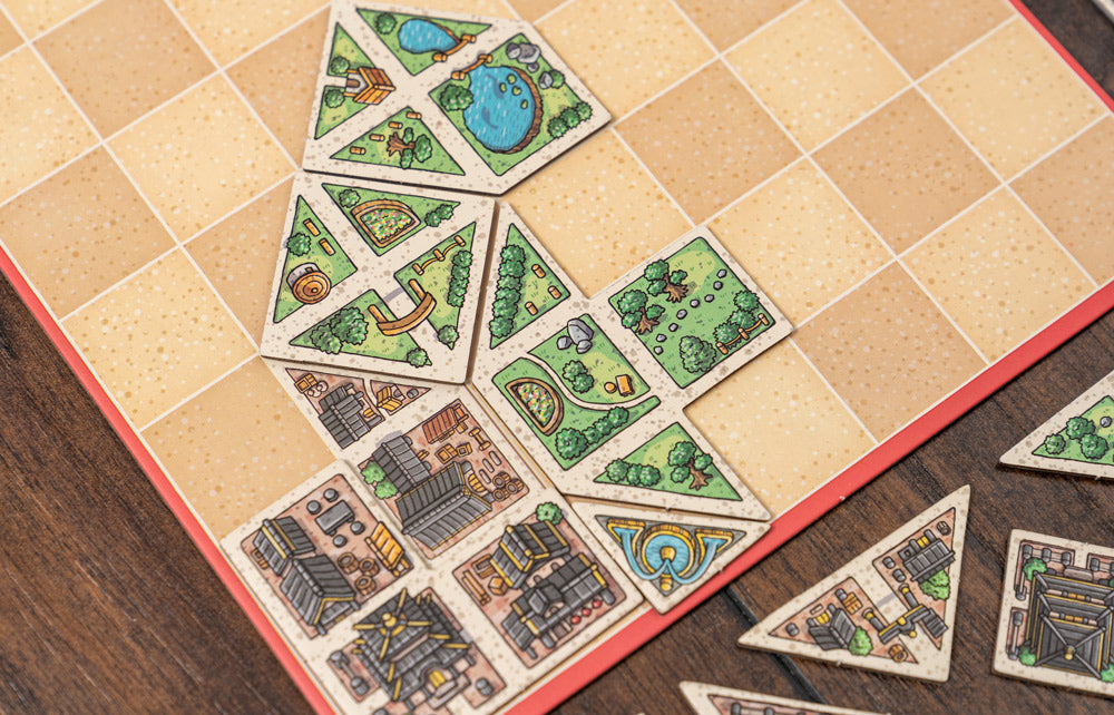 Colorful city grid partially filled with geometric tangram tiles during gameplay