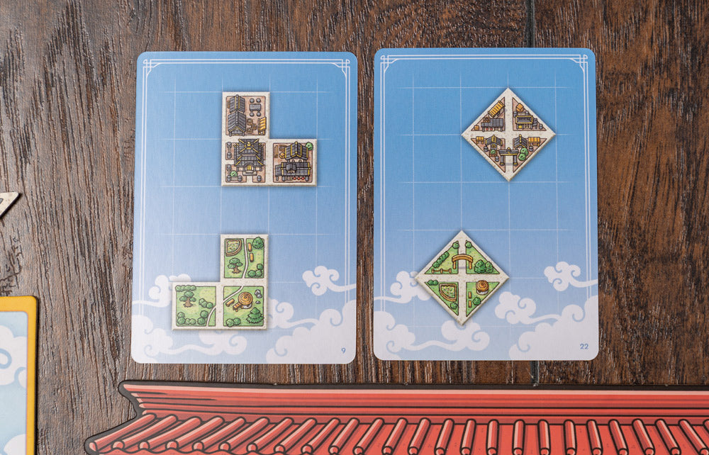 Players engaging with Tangram City, placing tiles on the board mid-game