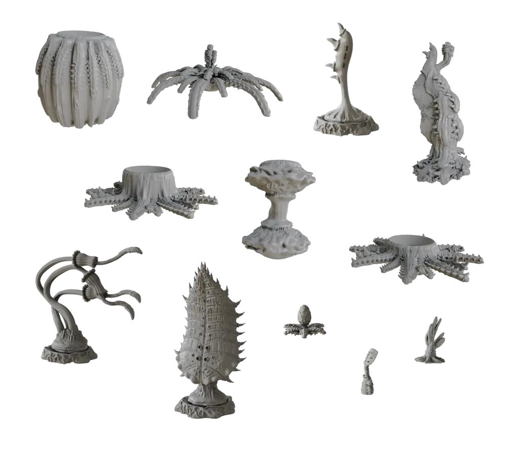 A collection of grey miniature models depicting diverse alien plants and monstrous terrain elements with spiky, ridged, and organic forms