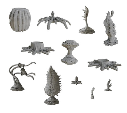 A collection of grey miniature models depicting diverse alien plants and monstrous terrain elements with spiky, ridged, and organic forms