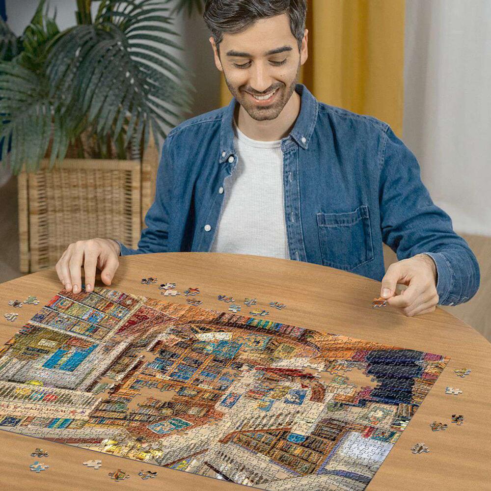 Man assembling The Fantasy Bookshop 1000 Piece Jigsaw Puzzle