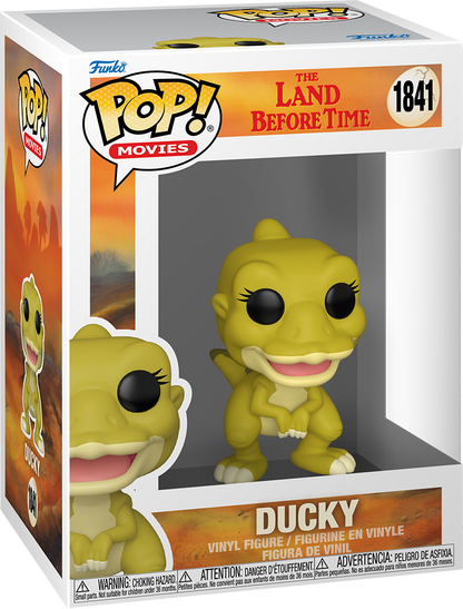 A Funko Pop! Ducky figure from The Land Before Time, a lime green dinosaur, displayed in its themed box